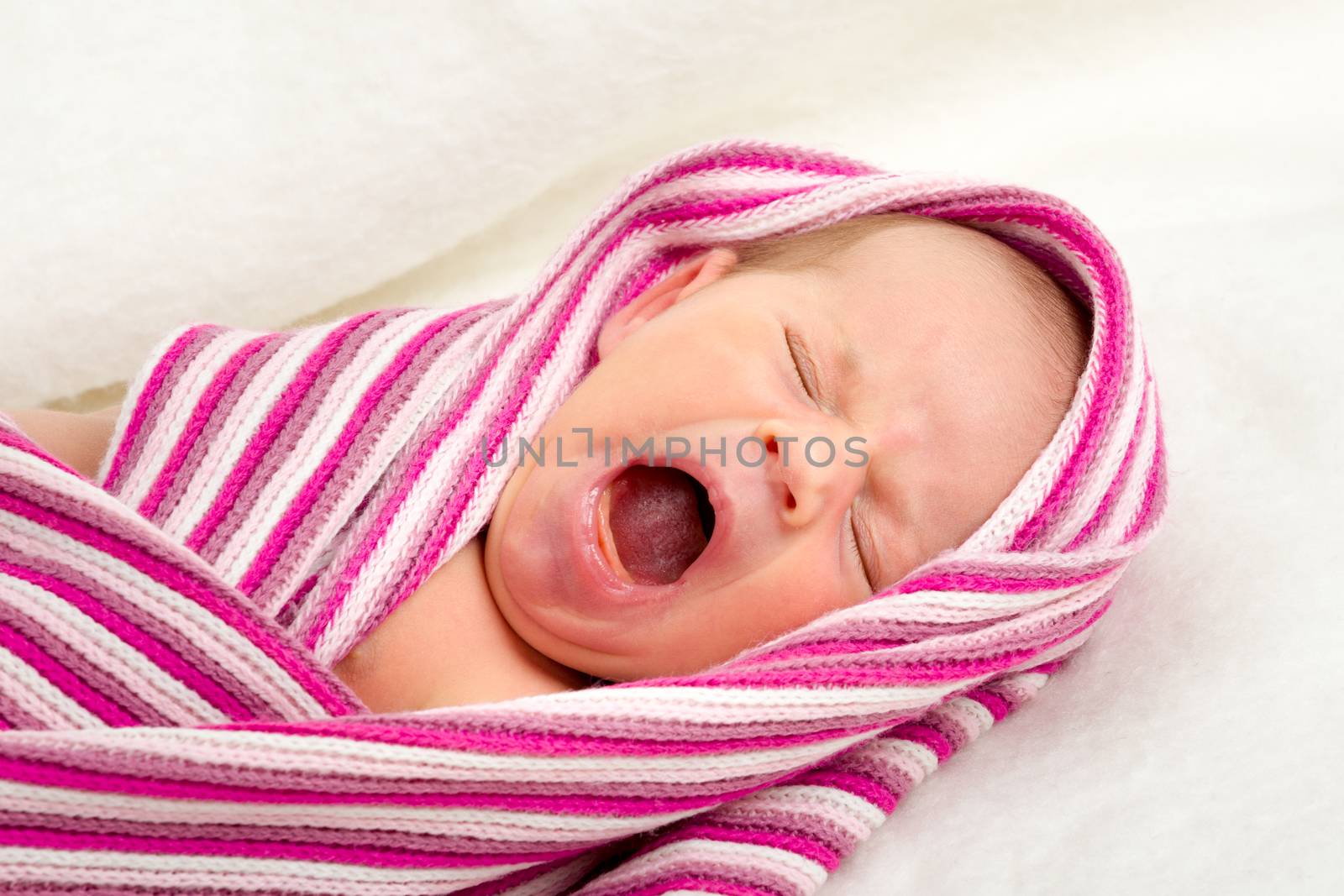 crying newborn baby in the hospital - the first week of the new life