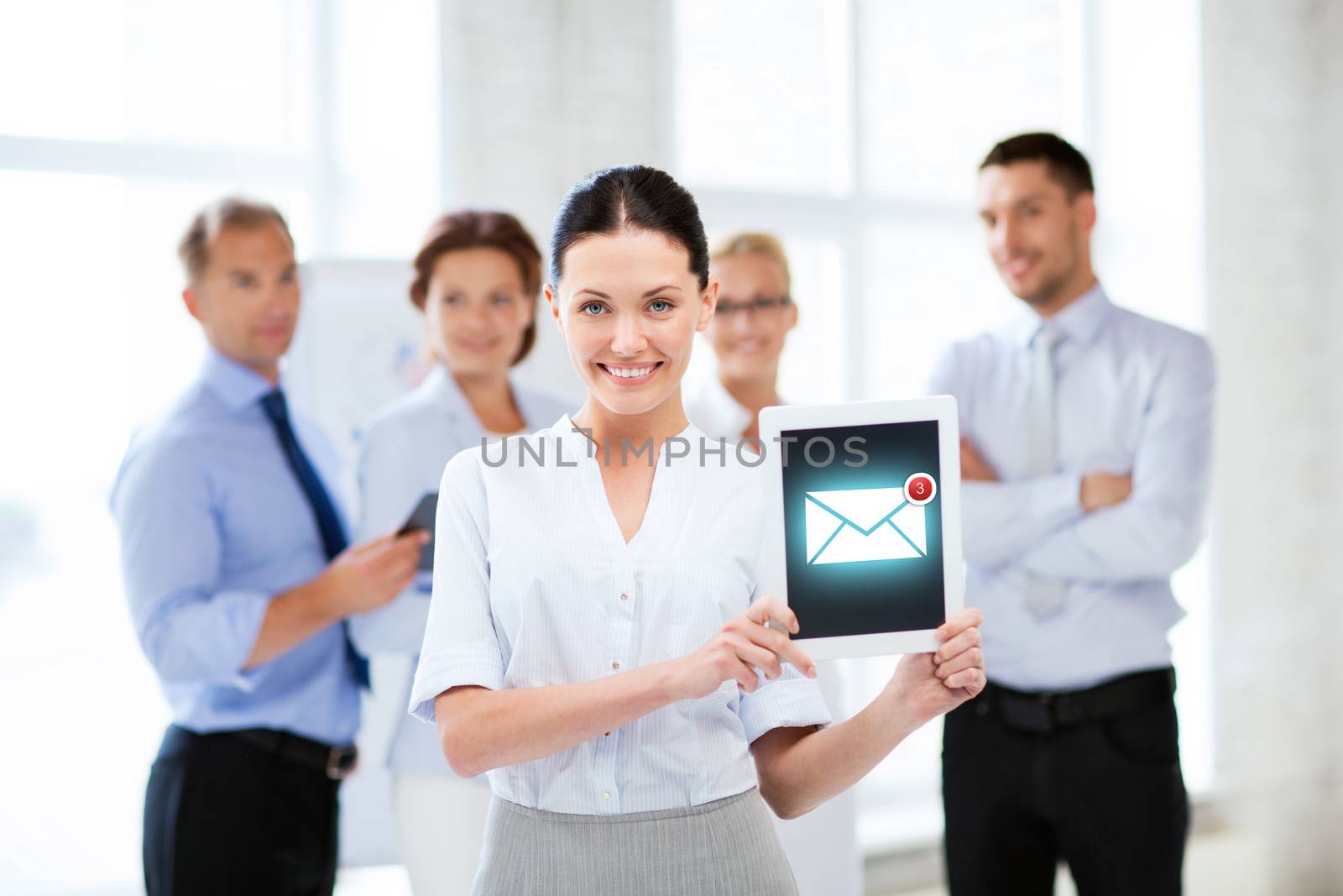 businesswoman holding tablet pc with email sign by dolgachov