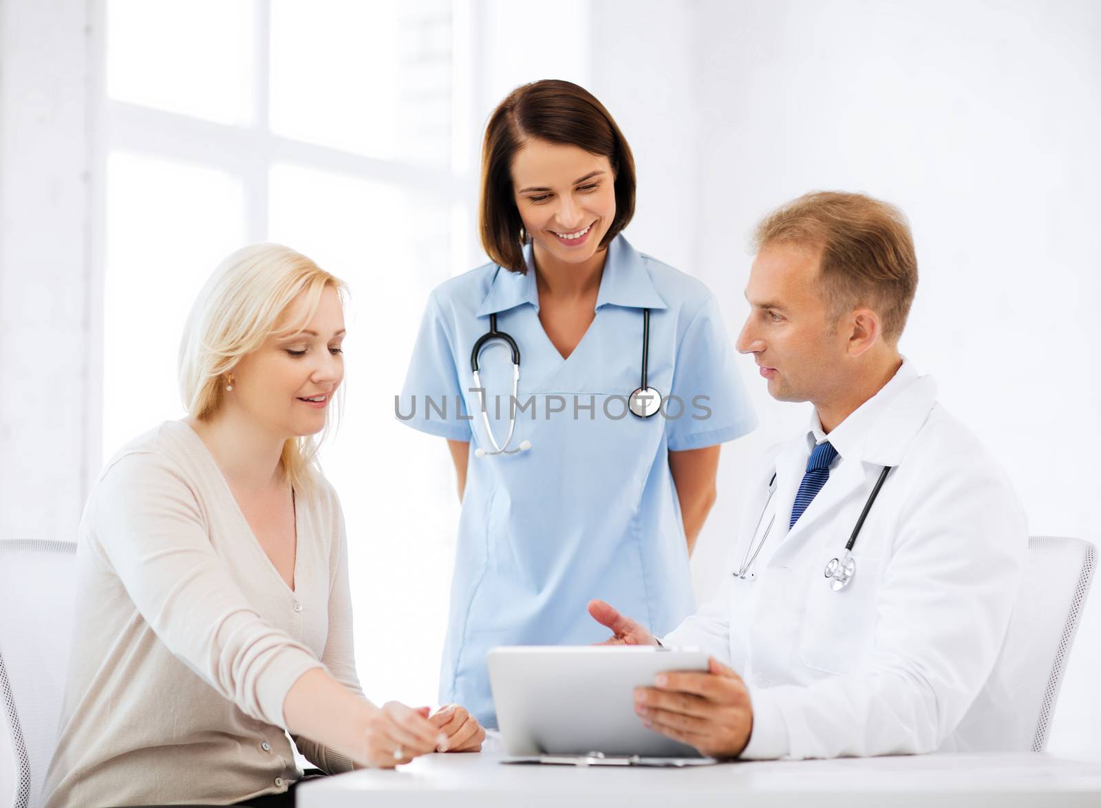 healthcare, medical and technology - doctor showing something to patient on tablet pc