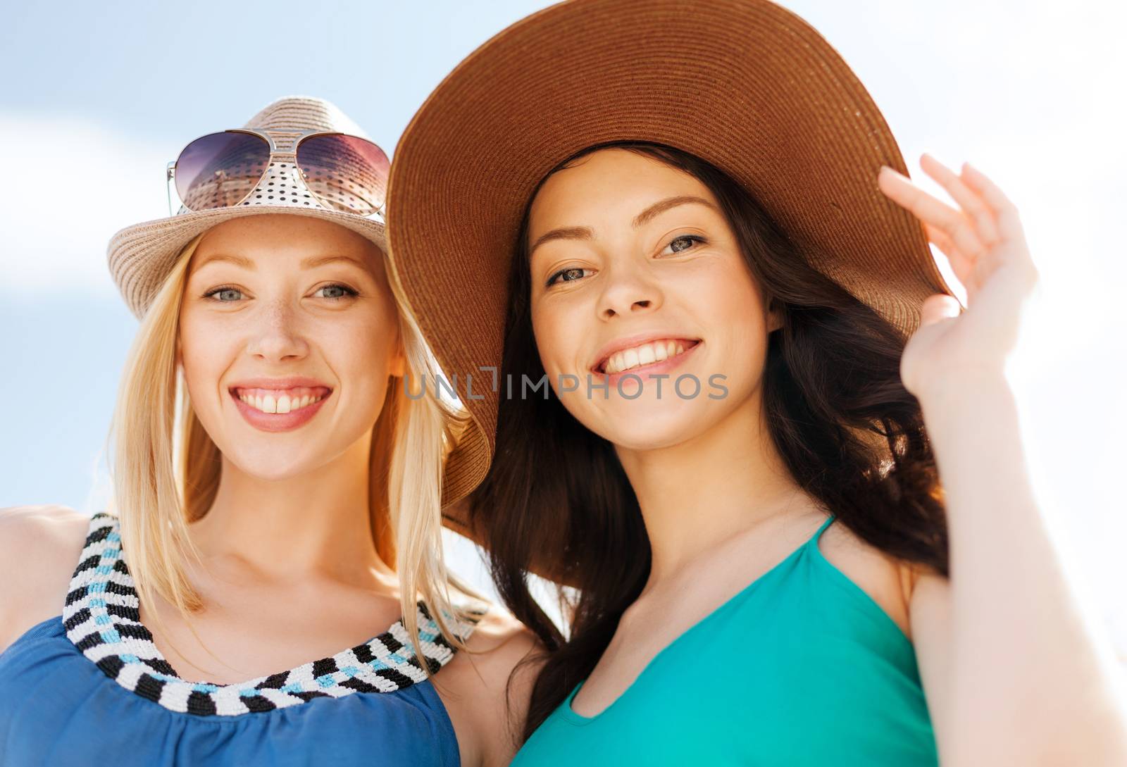 girls in hats on the beach by dolgachov