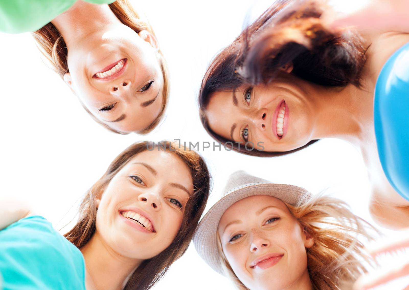 summer holidays and vacation concept - faces of girls looking down and smiling