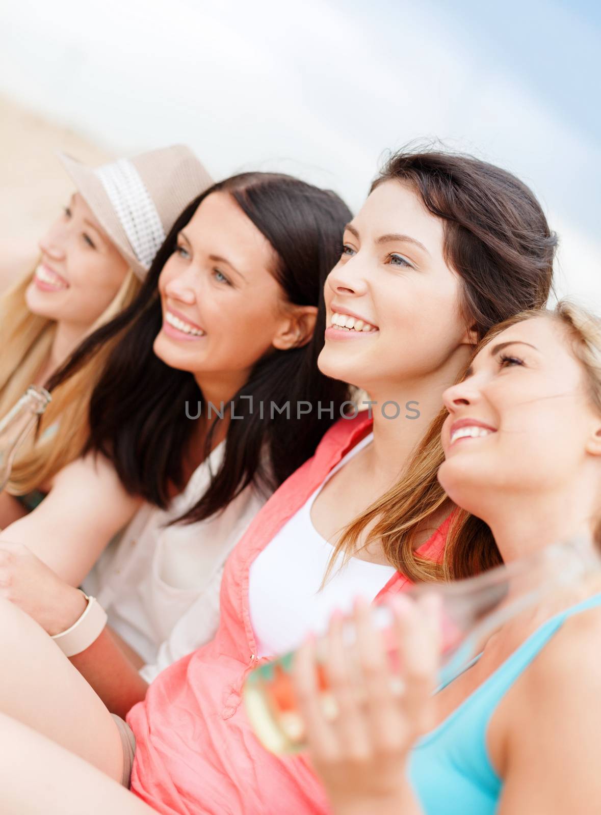 girls with drinks on the beach by dolgachov