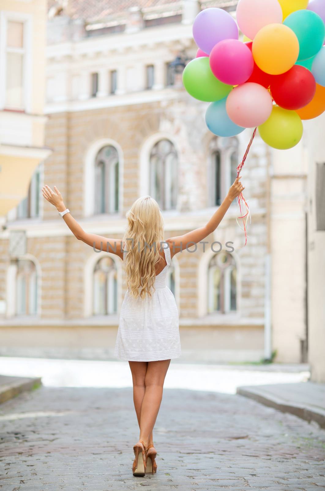 summer holidays, celebration and lifestyle concept - beautiful woman with colorful balloons in the city