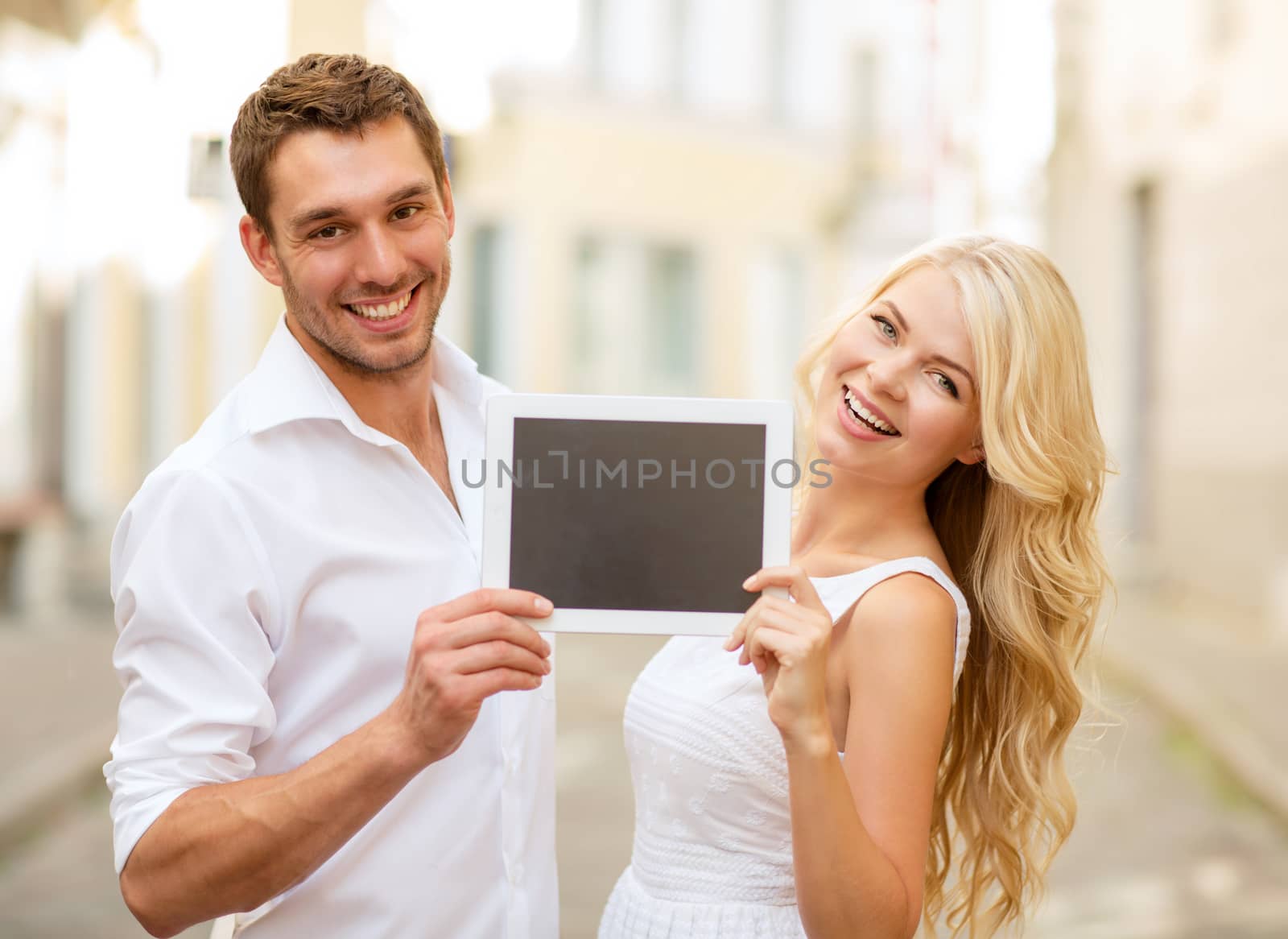 summer holidays, wedding, dating and technology concept - couple with tablet pc in the city