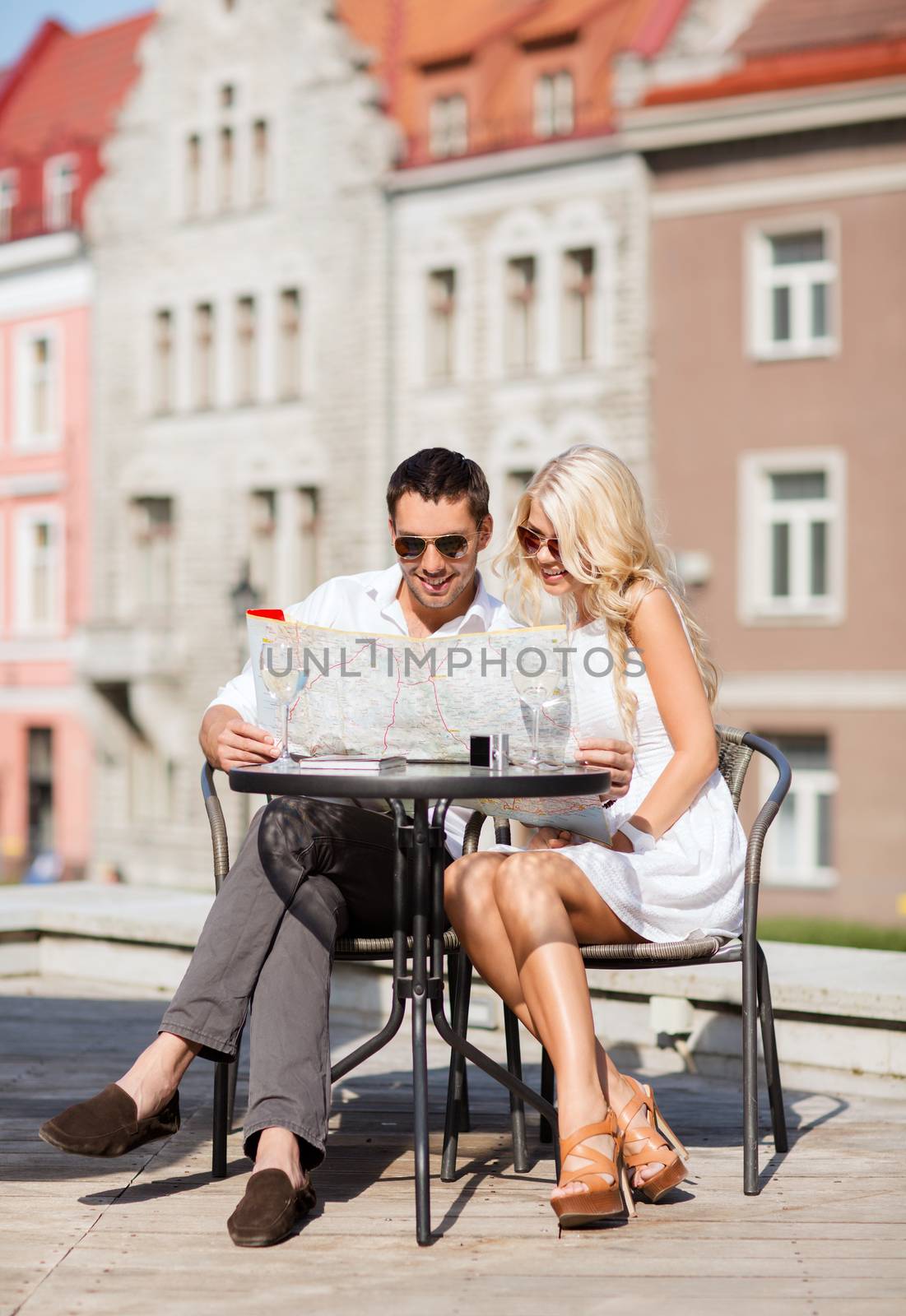 couple with map in cafe by dolgachov