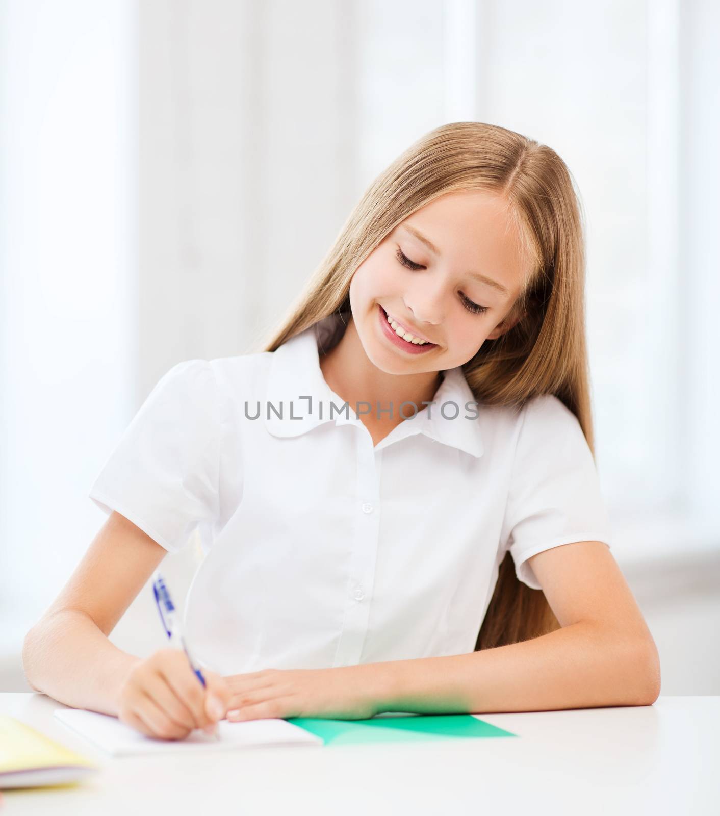 education and school concept - little student girl studying at school