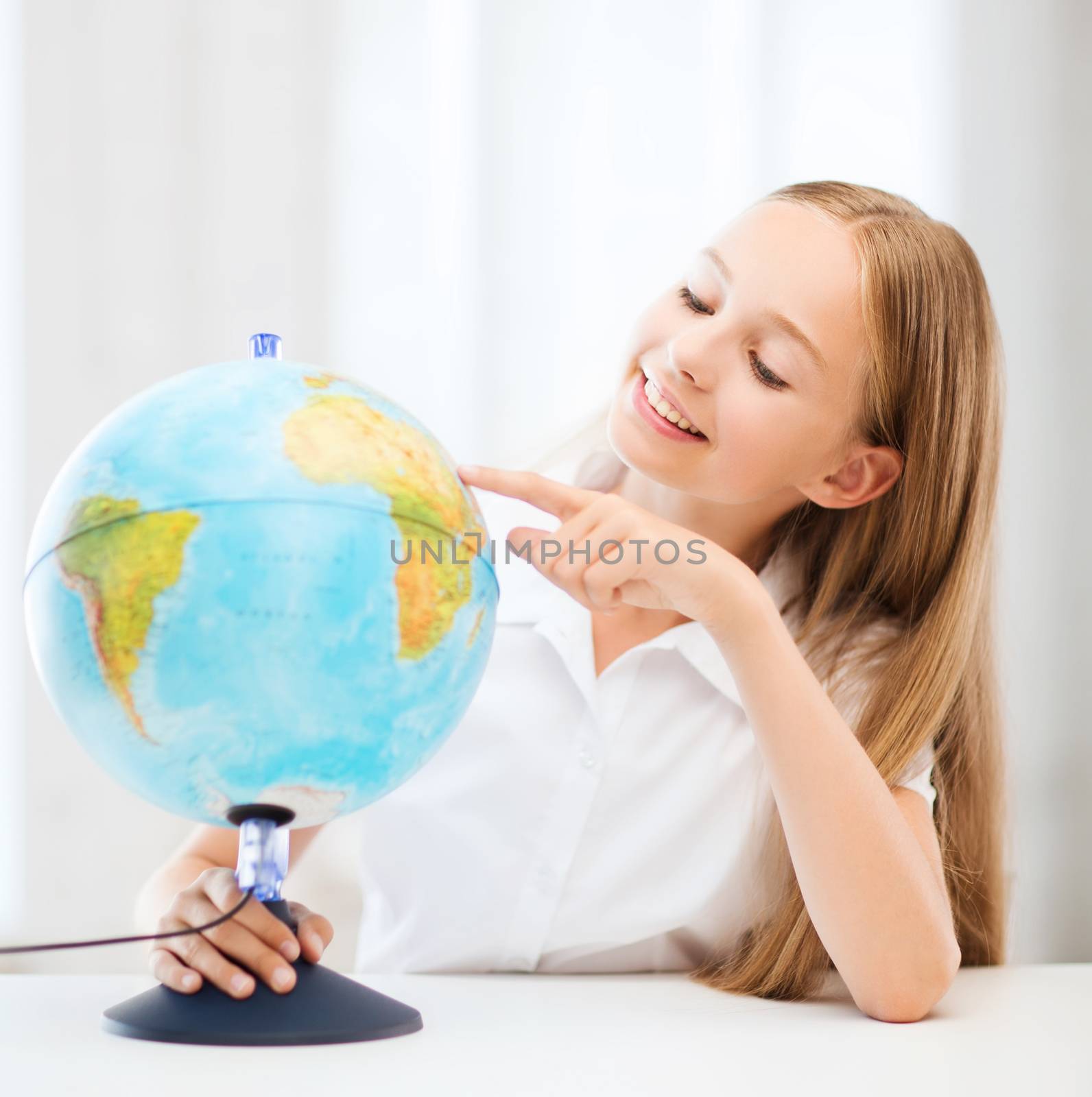 education and school concept - little student girl with globe at school