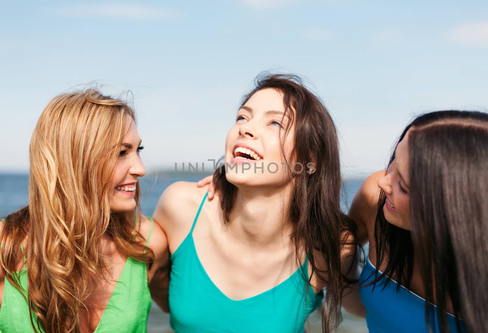 girls walking on the beach by dolgachov