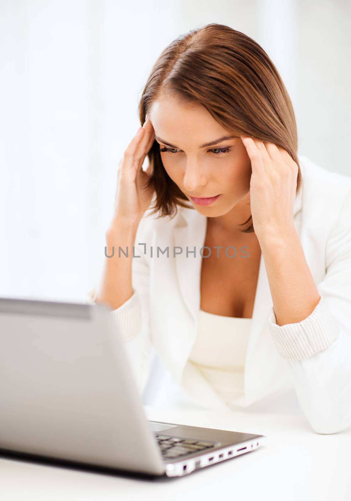 businesswoman with laptop in office by dolgachov