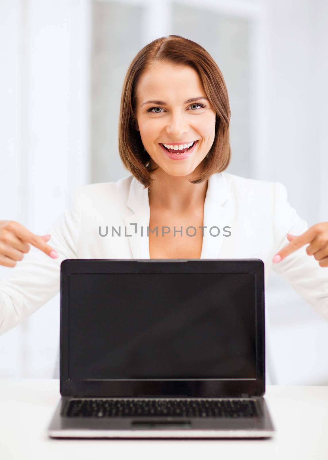 smiling woman with laptop pc by dolgachov