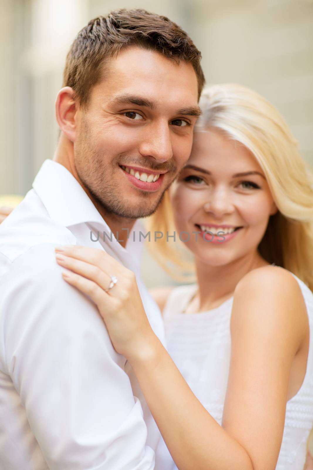 summer holidays, celebration and wedding concept - young engaged couple in the city