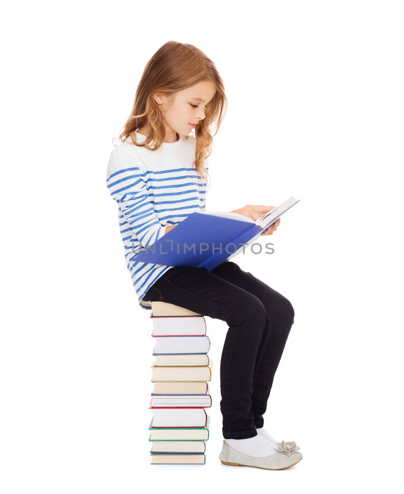 little student girl sitting on stack of books by dolgachov