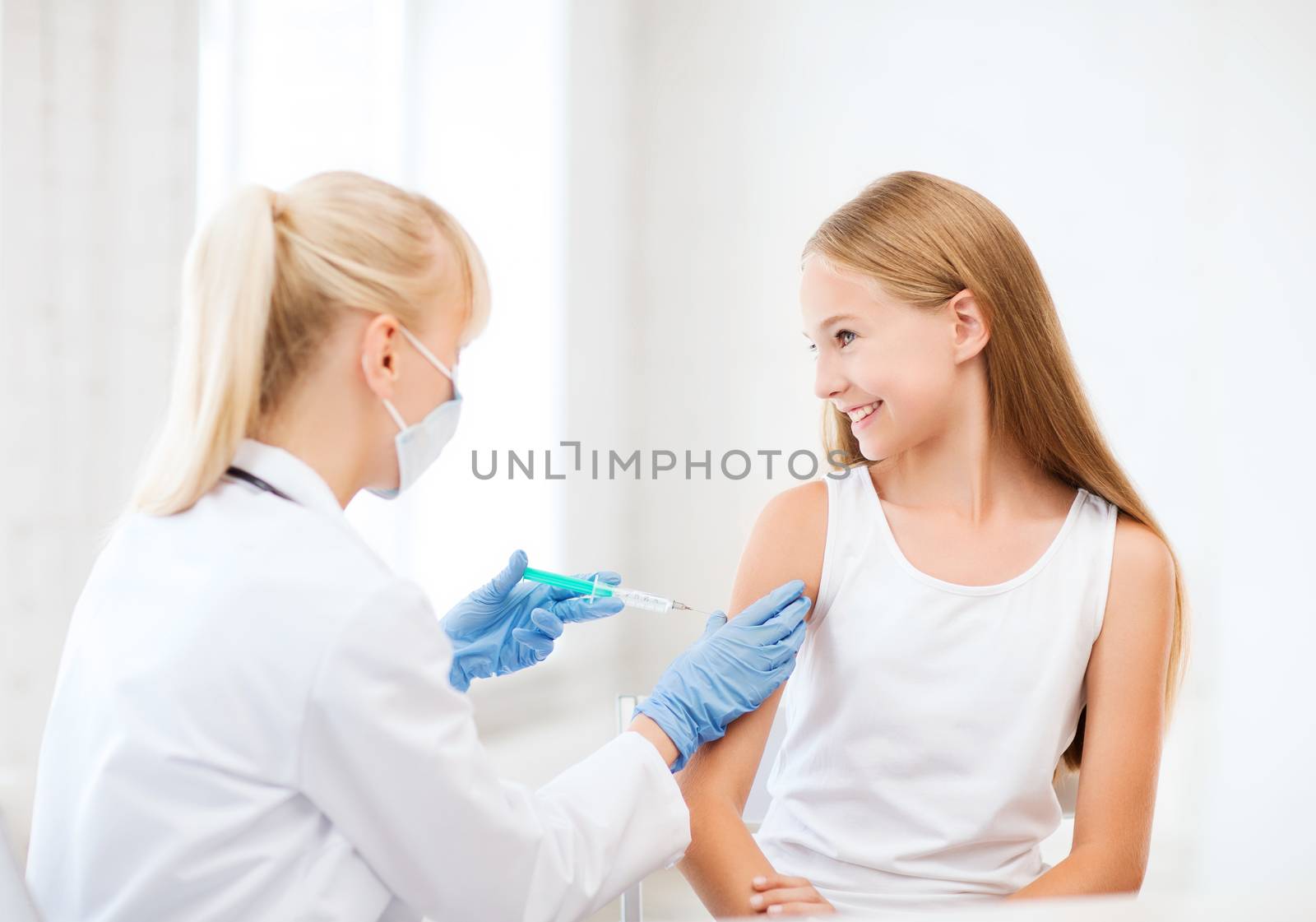 healthcare and medical concept - doctor doing vaccine to child in hospital