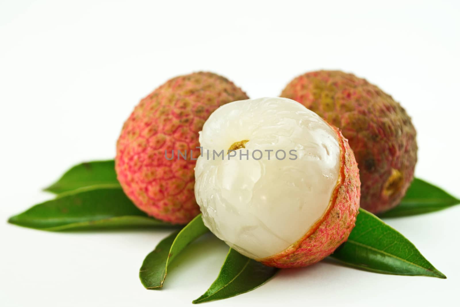 fresh lychees on white background by Thanamat