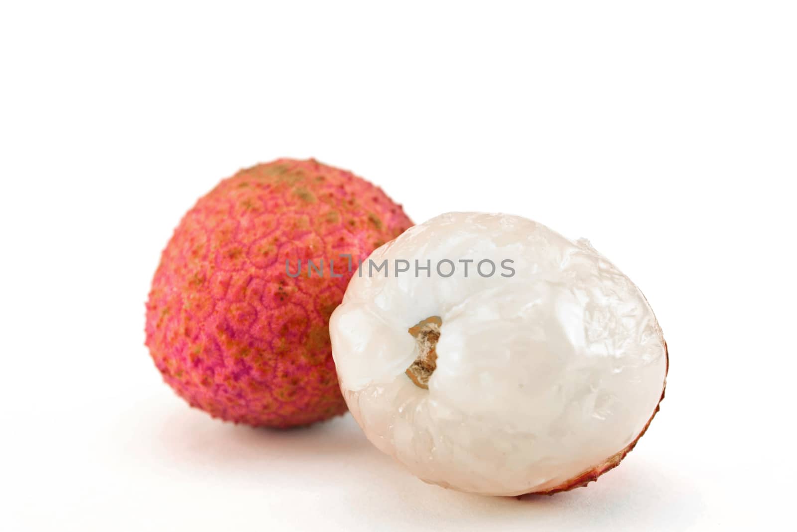 fresh lychees on white background by Thanamat