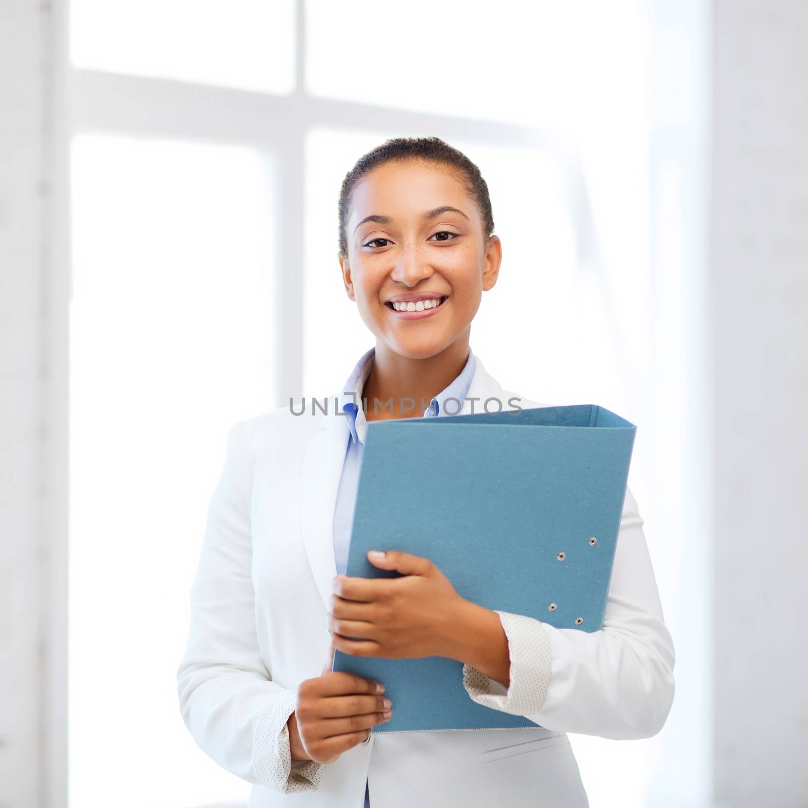 business and education concept - african businesswoman with folder in office