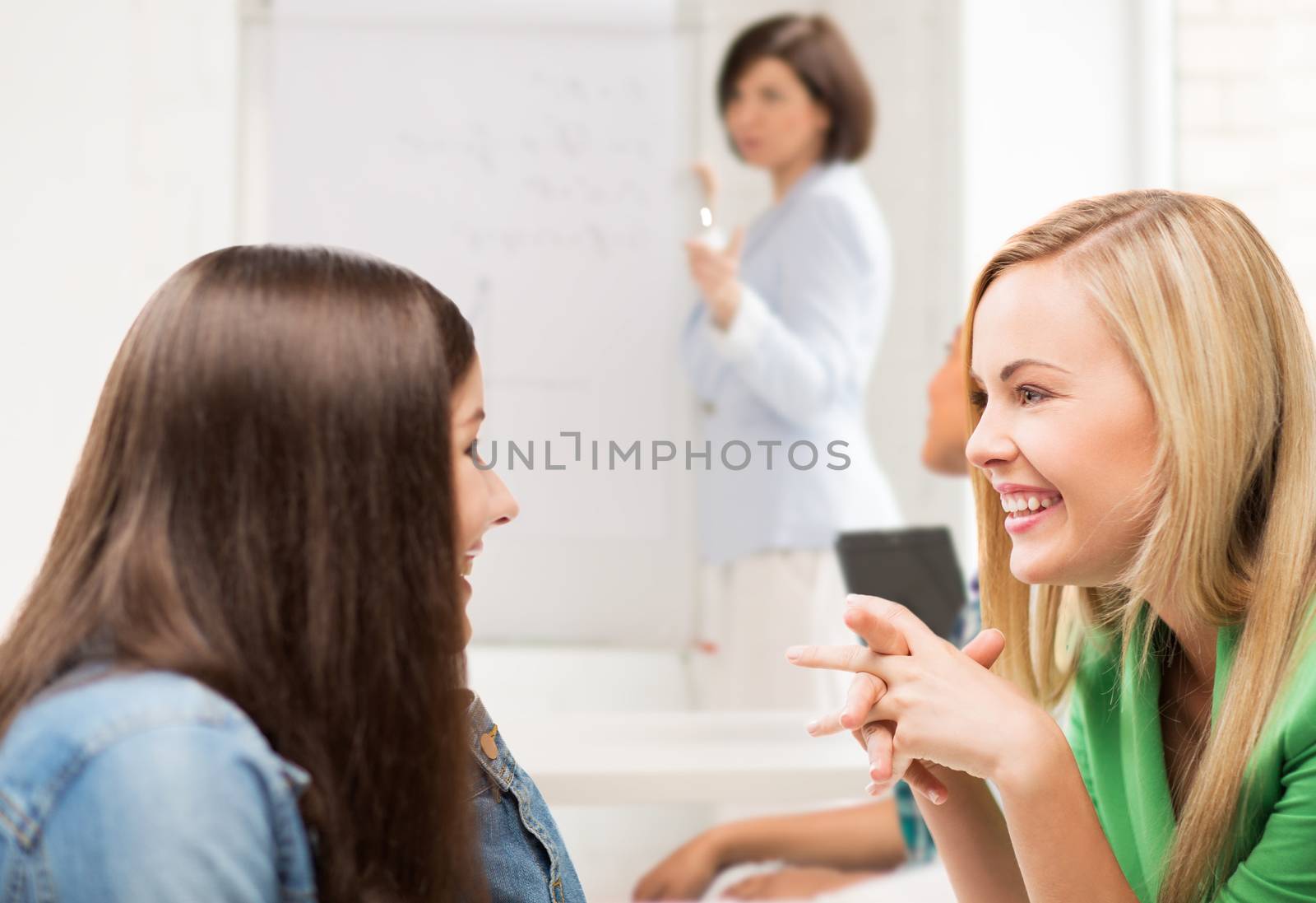 student girls gossiping at school by dolgachov