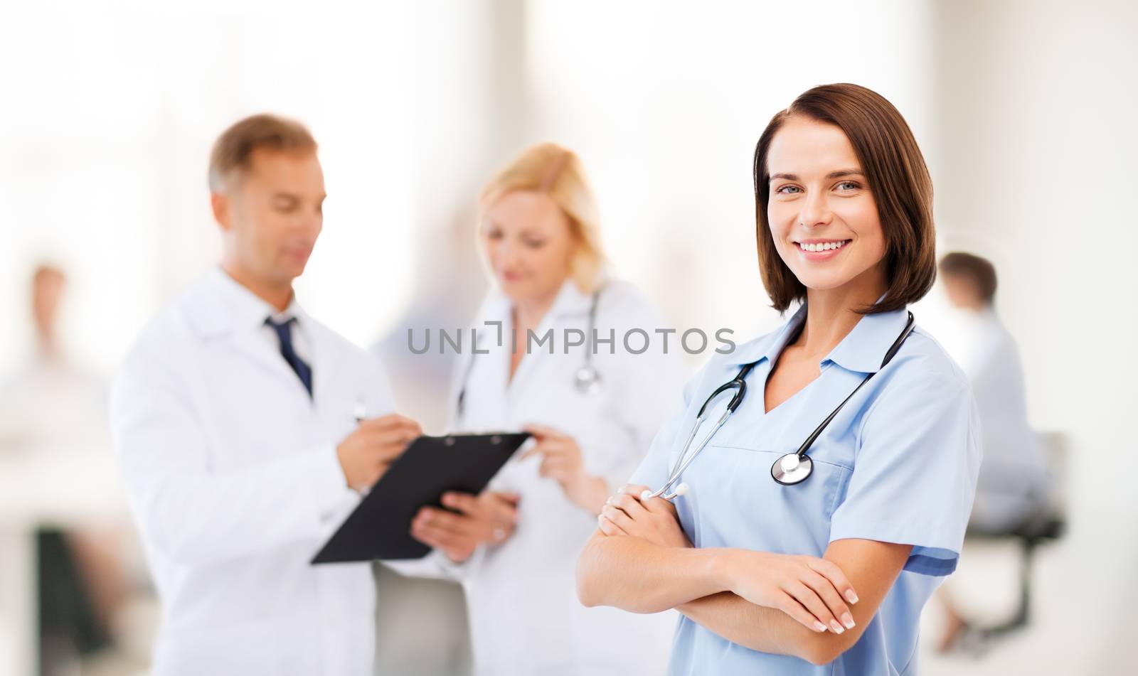 healthcare and medical concept - young female doctor with colleagues in hospital