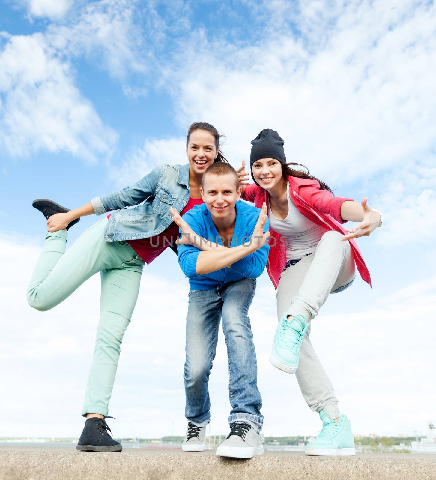 group of teenagers dancing by dolgachov