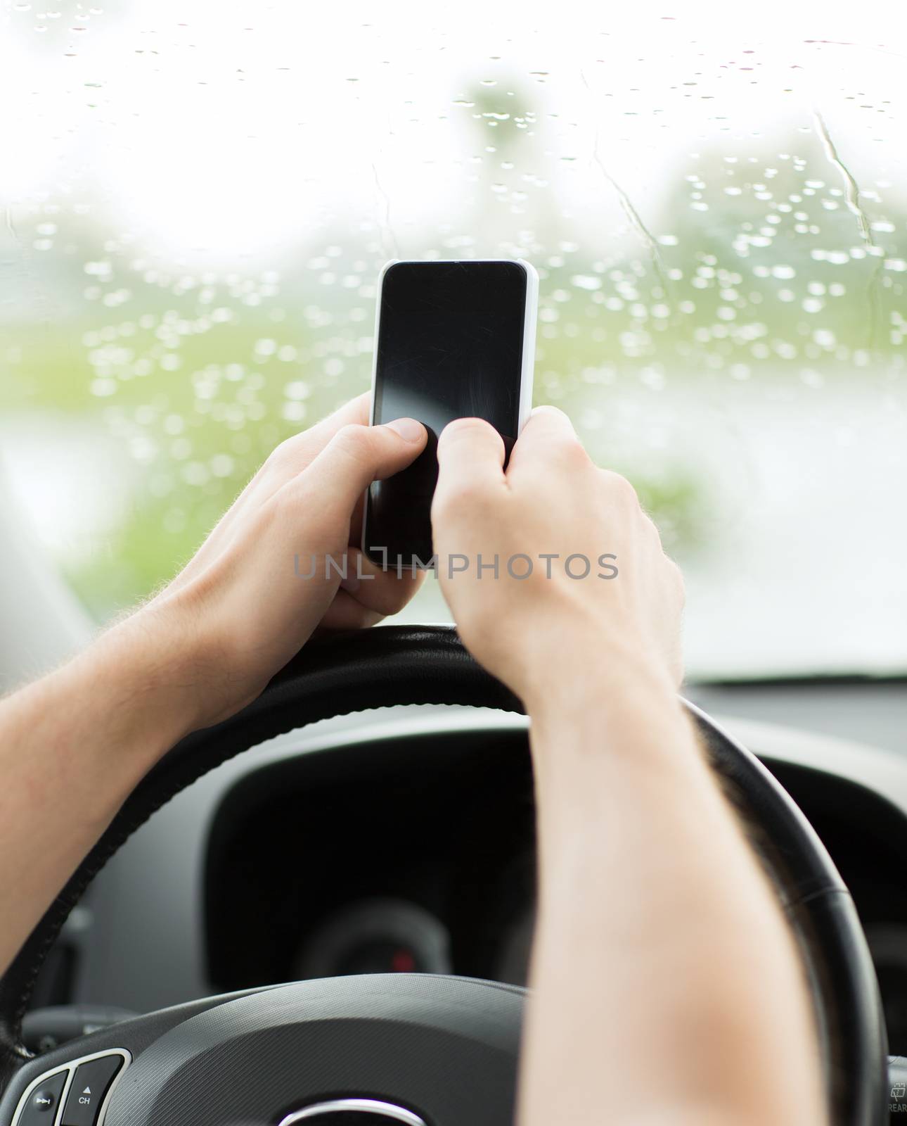 man using phone while driving the car by dolgachov
