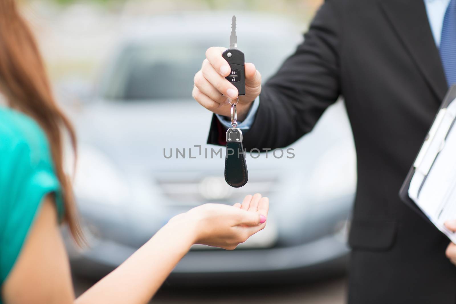customer and salesman with car key by dolgachov