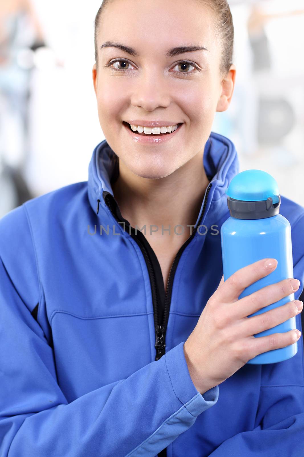 Portrait of a woman holding a blue bottle