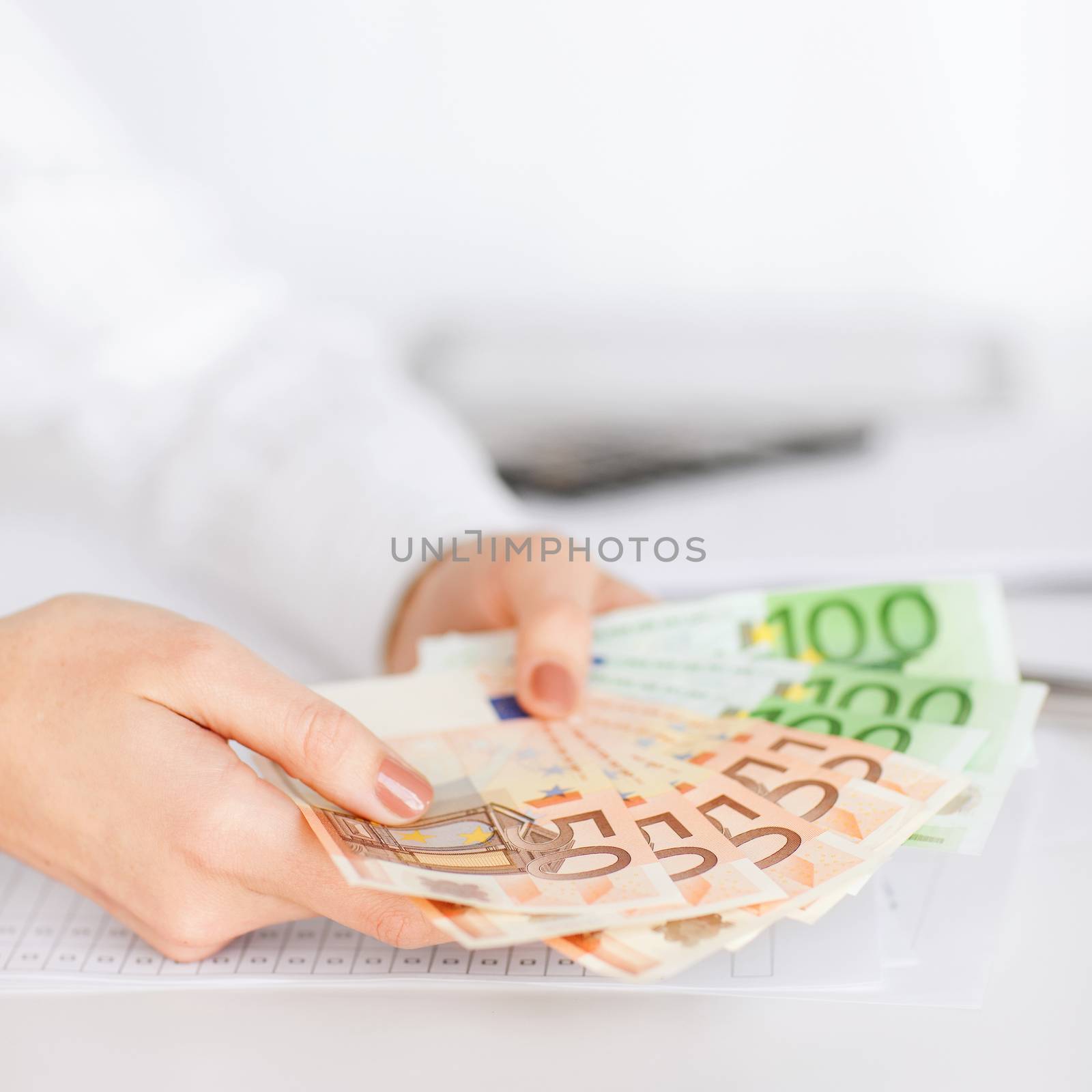 woman hands with euro cash money by dolgachov