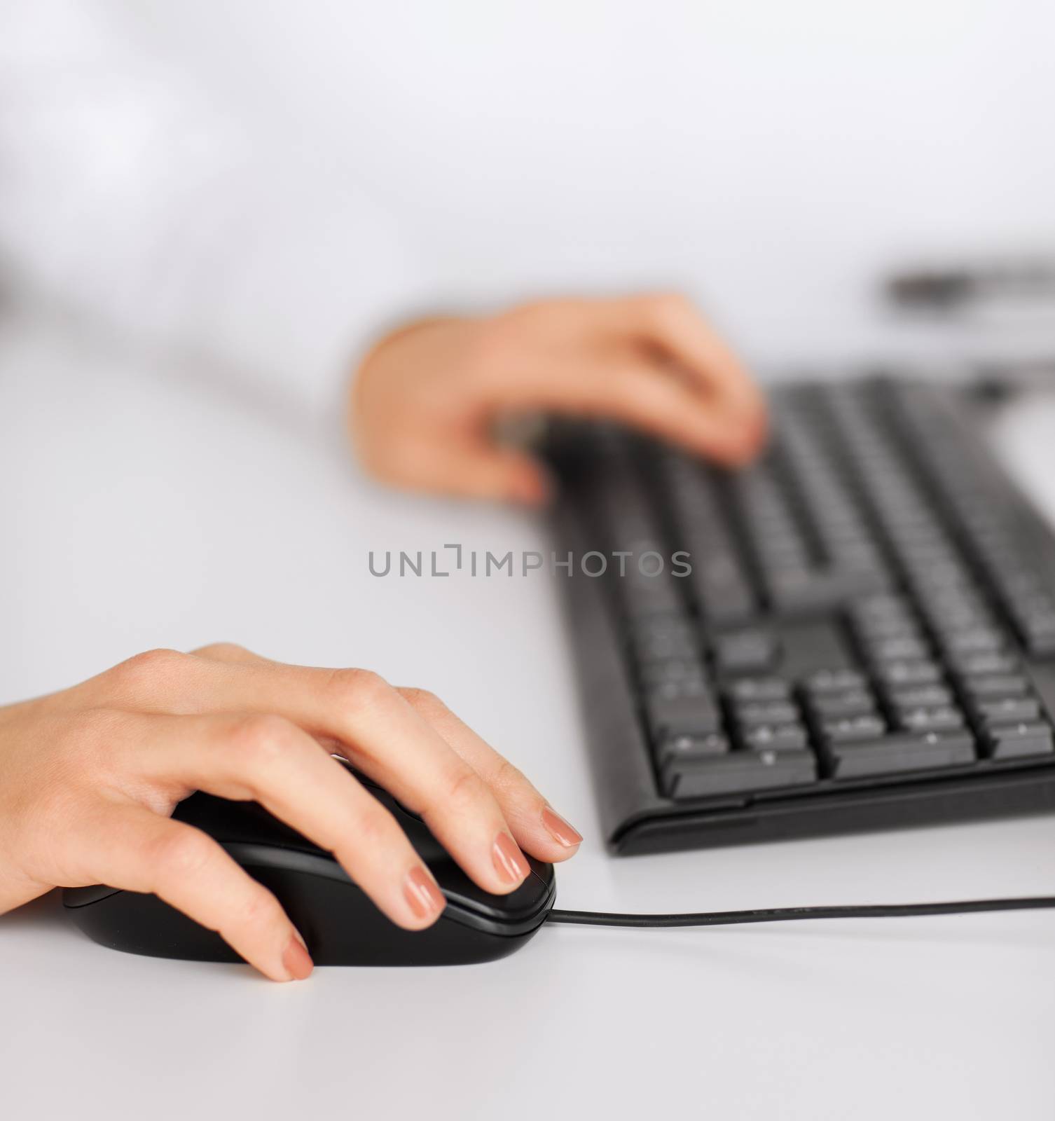 woman hands with keyboard and mouse by dolgachov