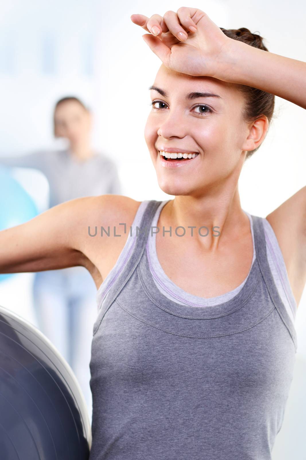 A group of women exercising on a mat with ball