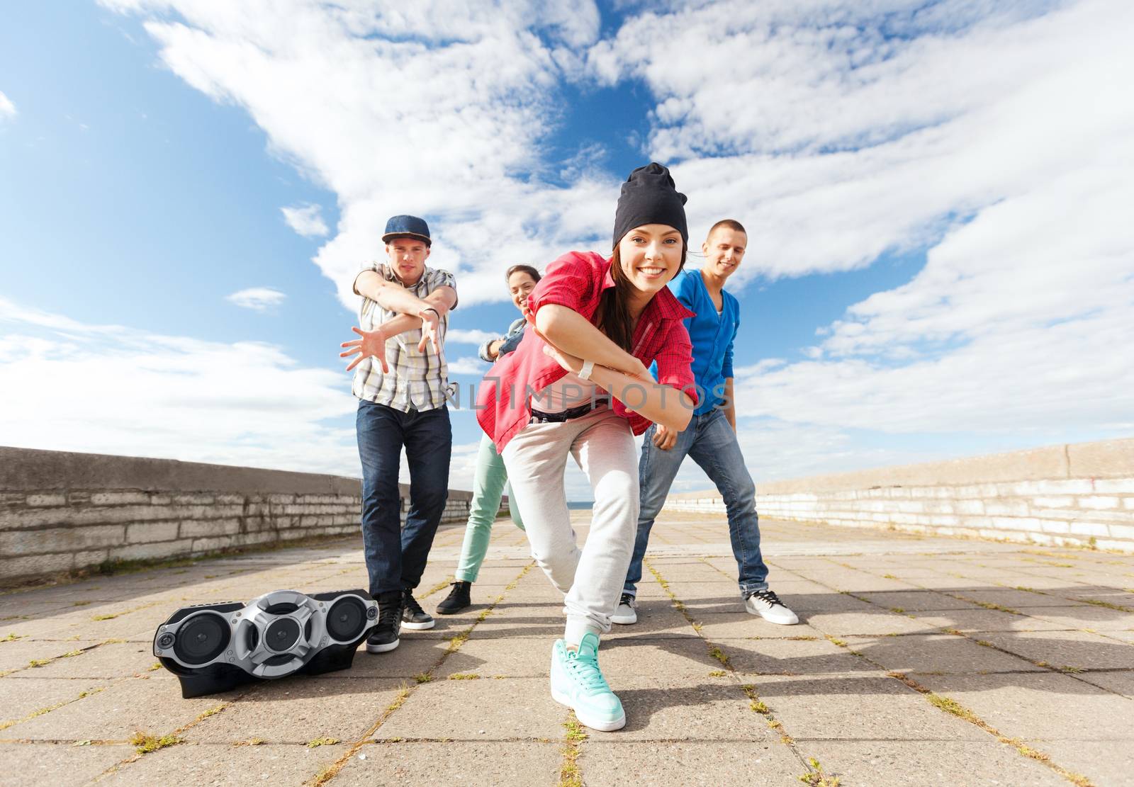 sport, dancing and urban culture concept - group of teenagers dancing