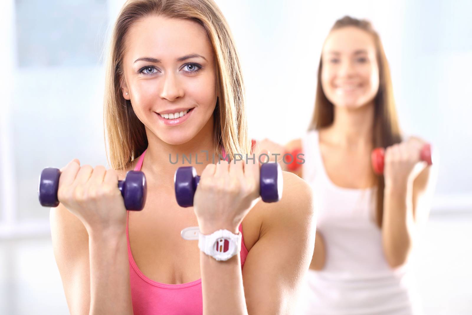 Beautiful woman at the gym train hand muscles