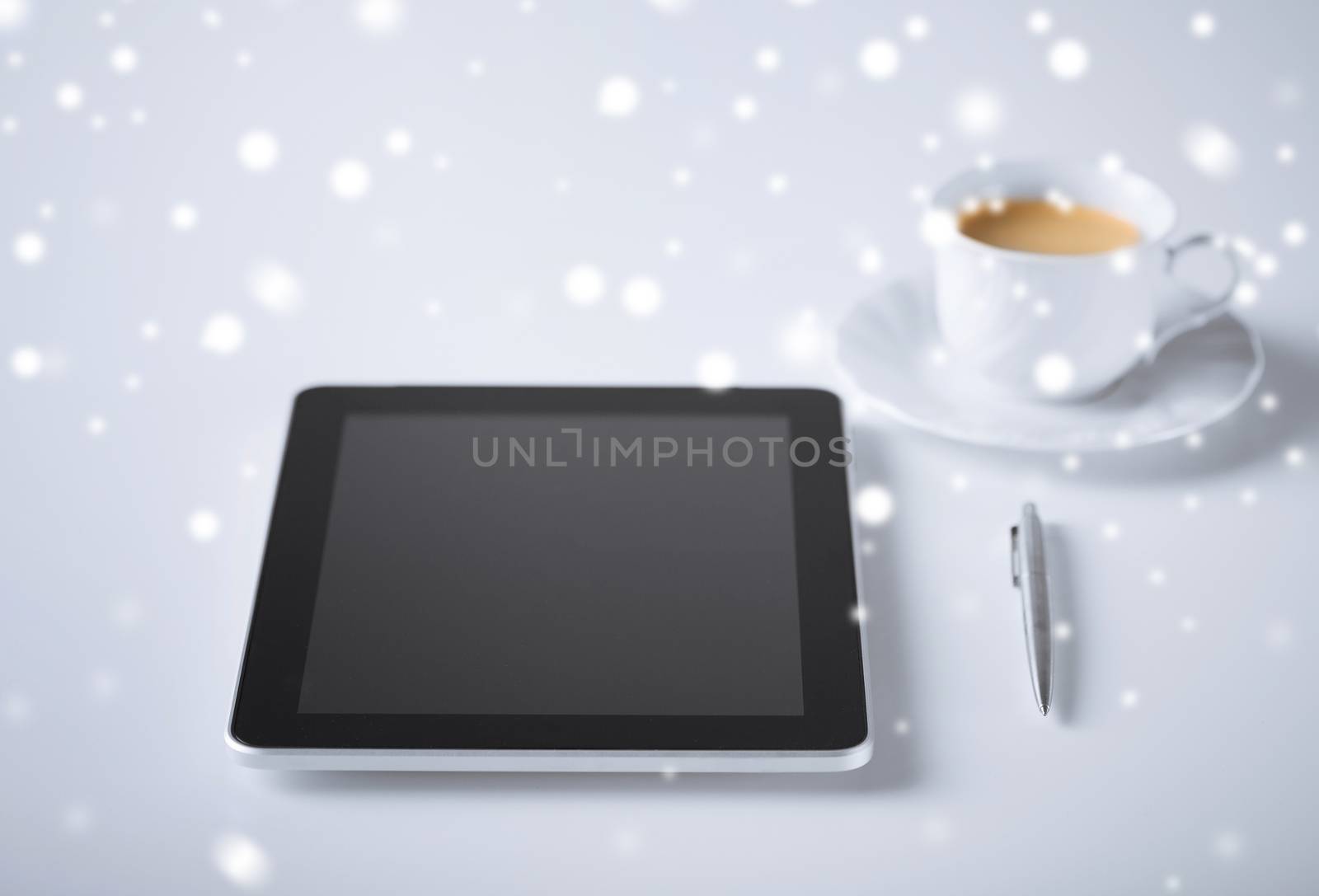 business and technology concept - tablet pc with cup of coffee