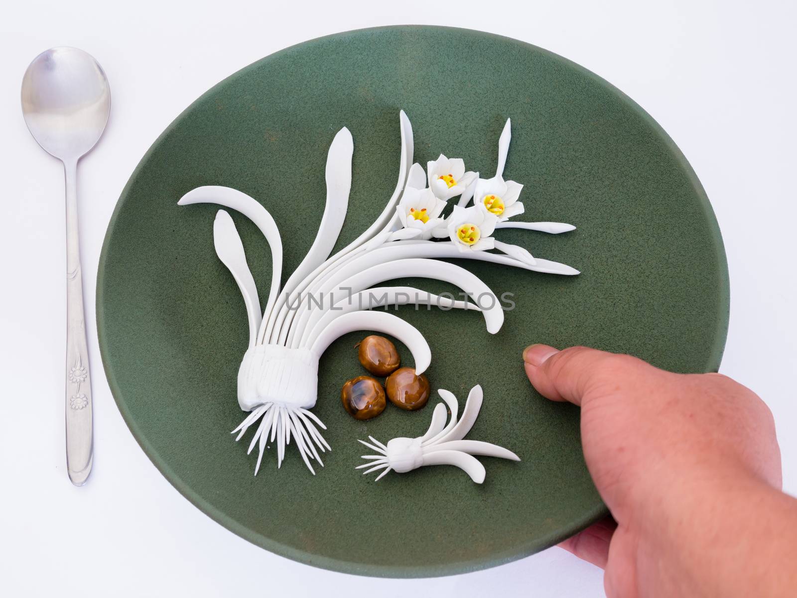 Dish decorated with flowers, which are handmade. Art is beautiful pottery