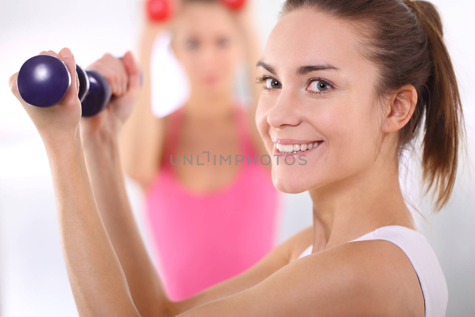 Beautiful women train with weights