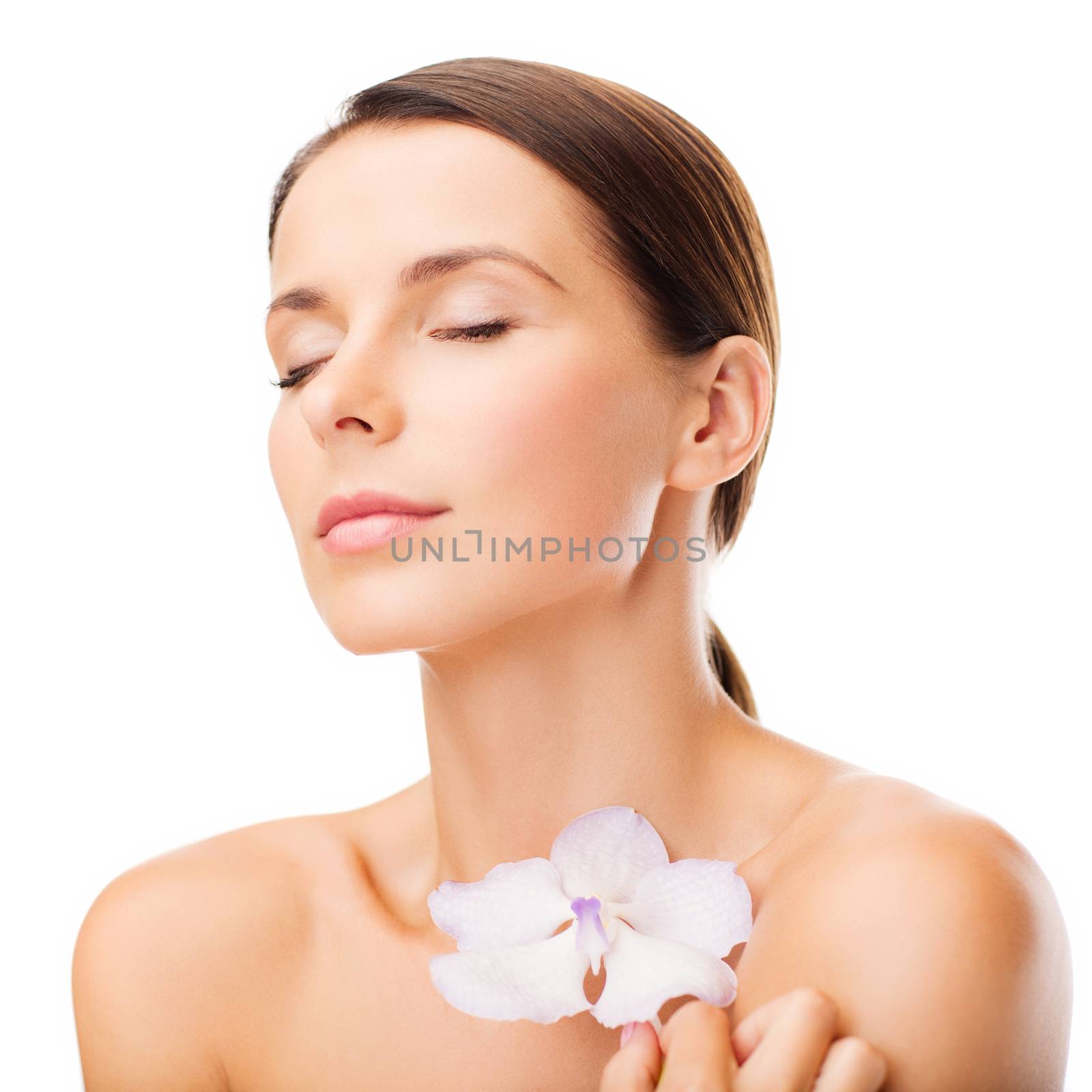 health and beauty concept - relaxed woman with orhid flower