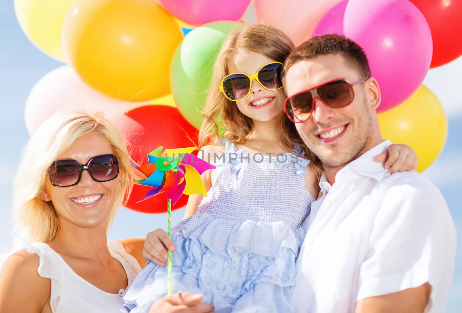 summer holidays, celebration, children and people concept - family with colorful balloons