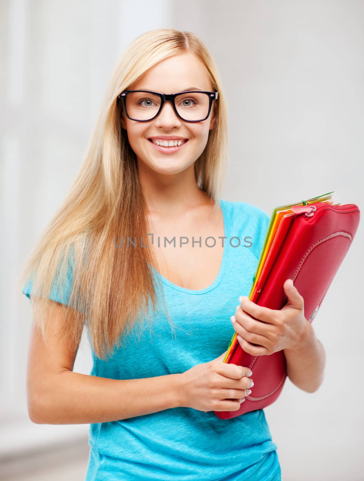 smiling student with folders by dolgachov
