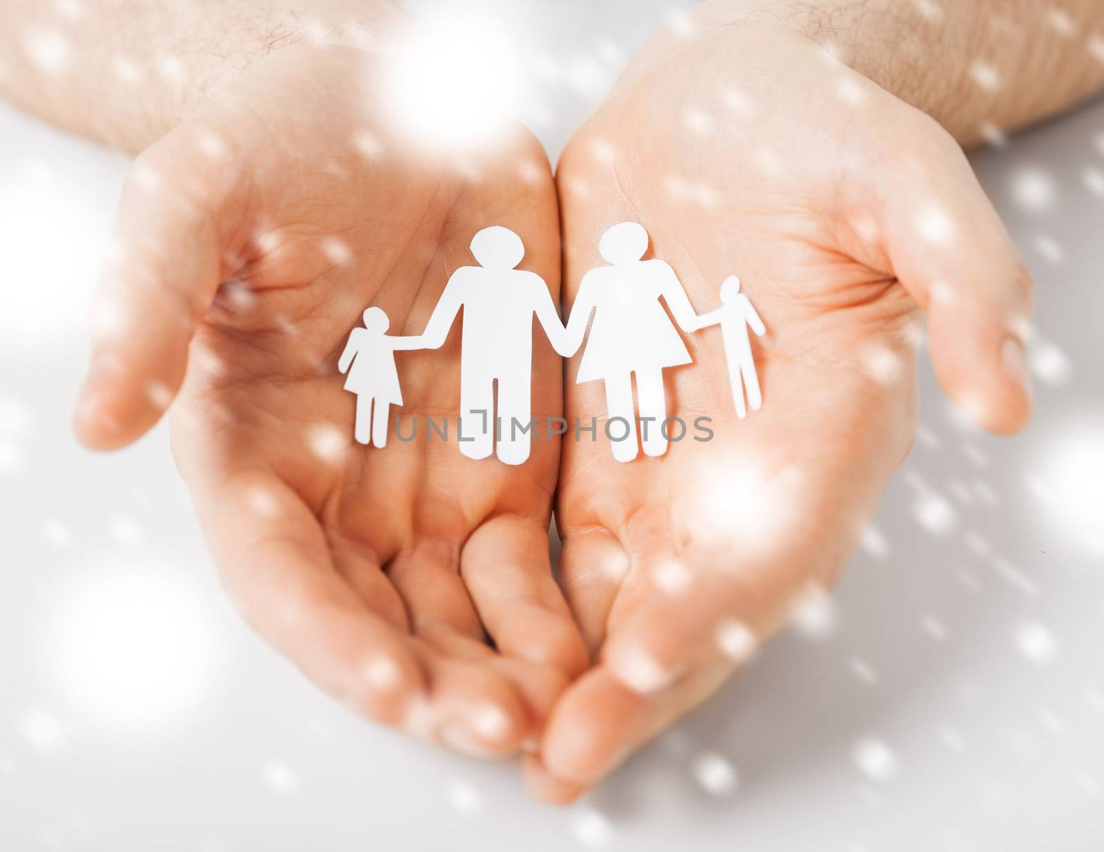 love, romance, safety concept - man hands showing family of paper people