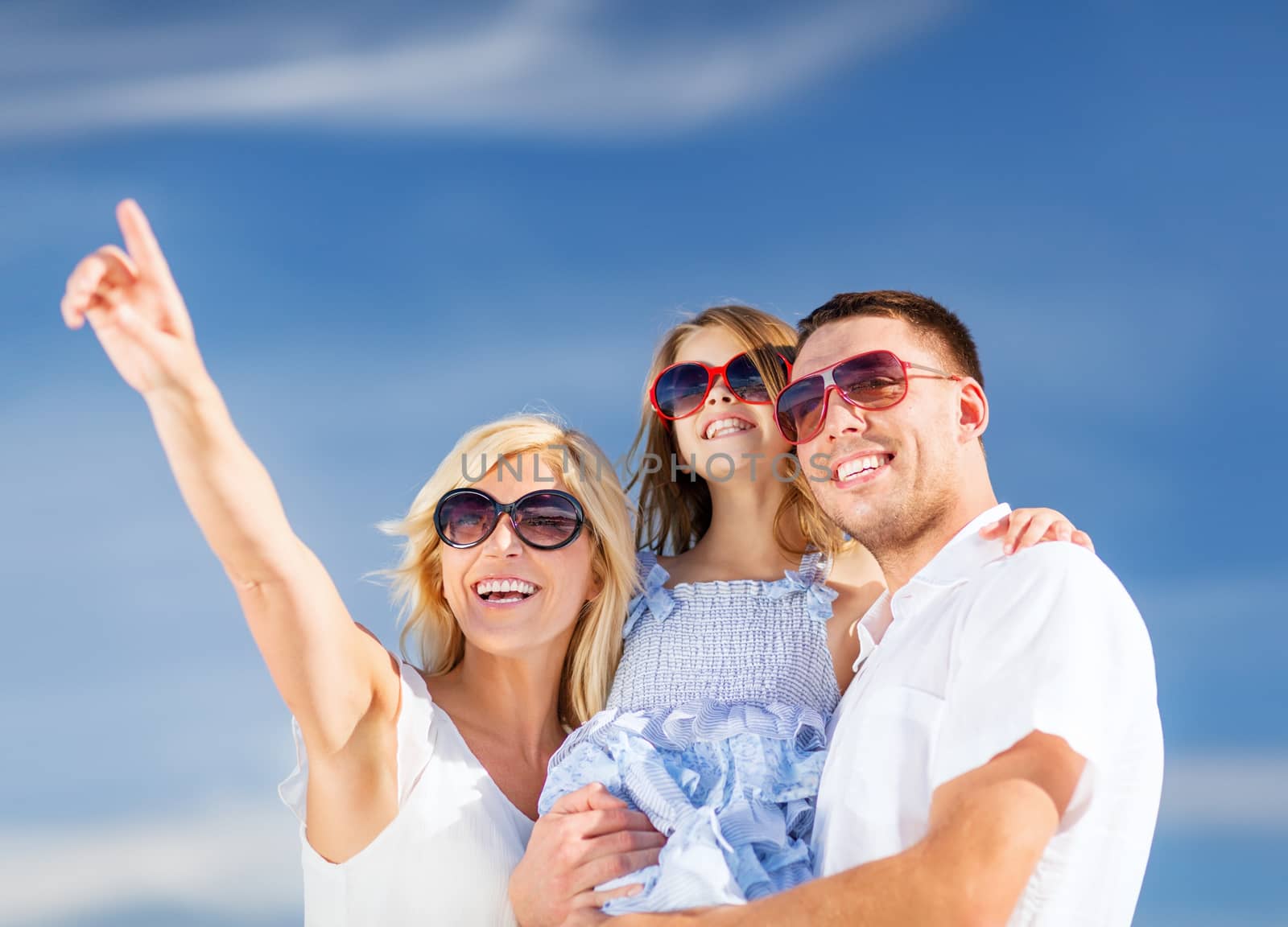 summer holidays, children and people concept - happy family with blue sky