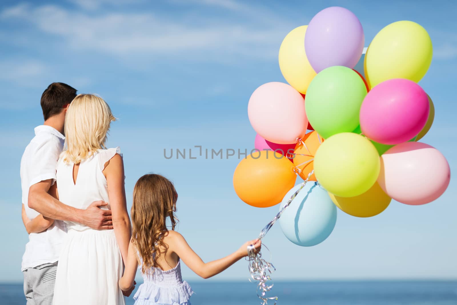 summer holidays, celebration, children and people concept - family with colorful balloons