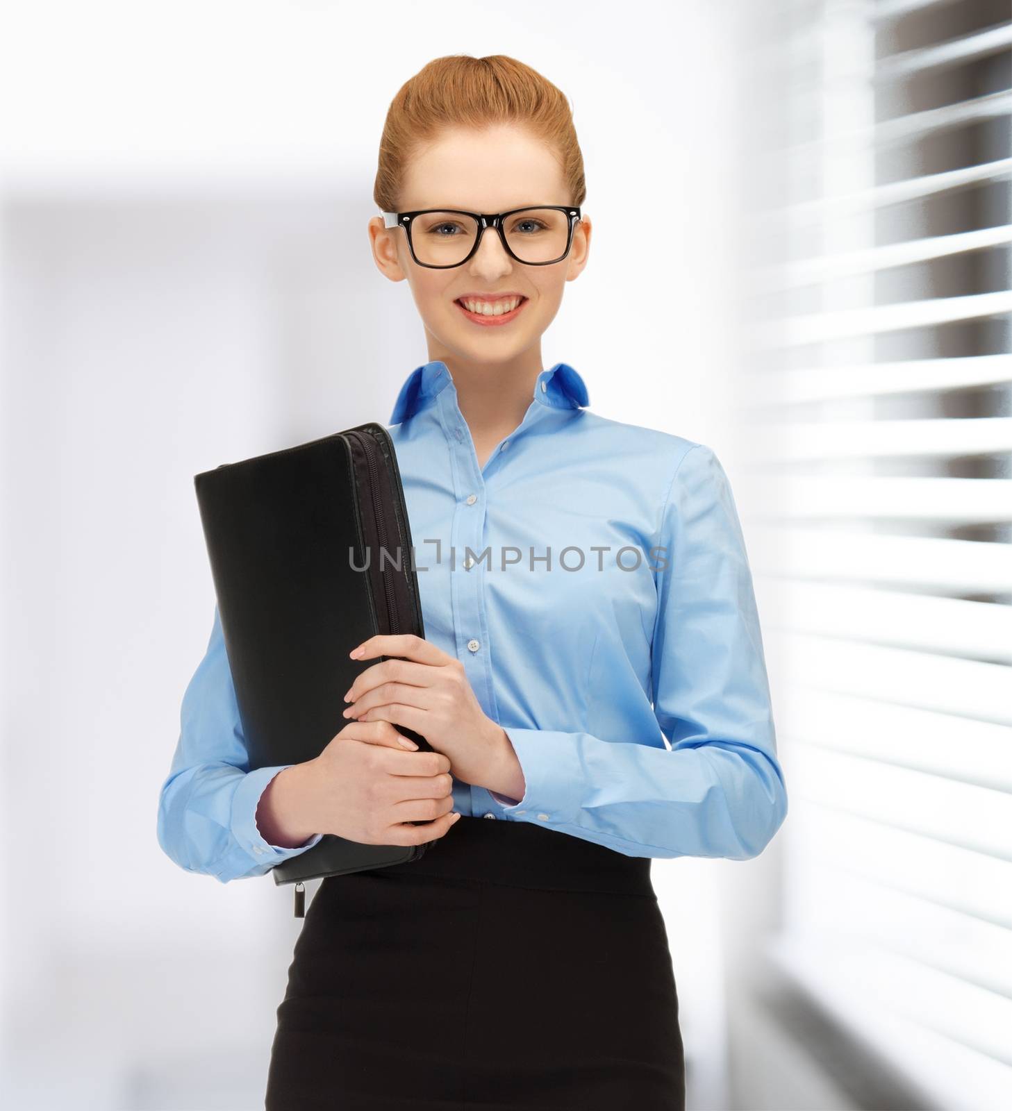 office, buisness, education concept - attractive businesswoman with folders