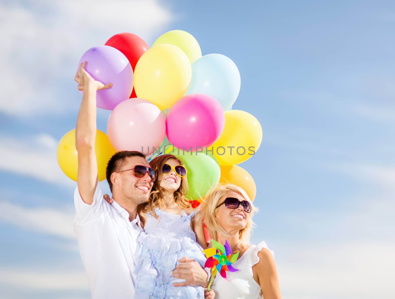 summer holidays, celebration, children and people concept - family with colorful balloons