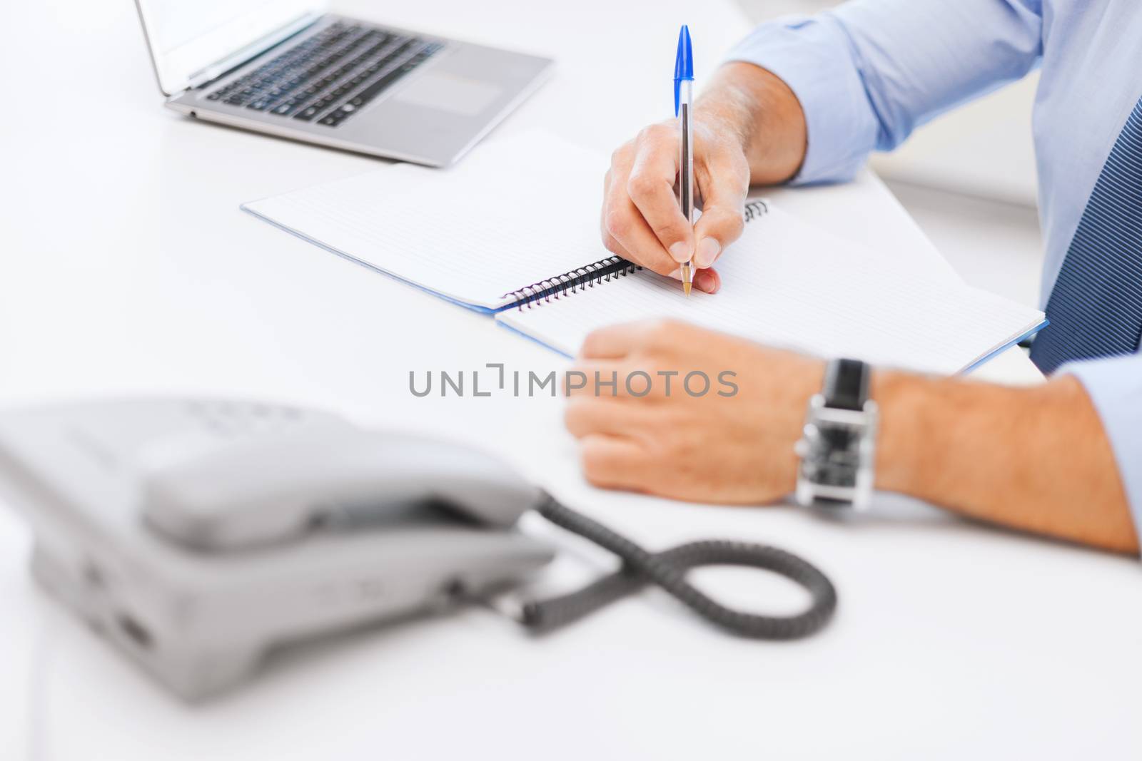 business, office, school and education concept - businessman writing in notebook