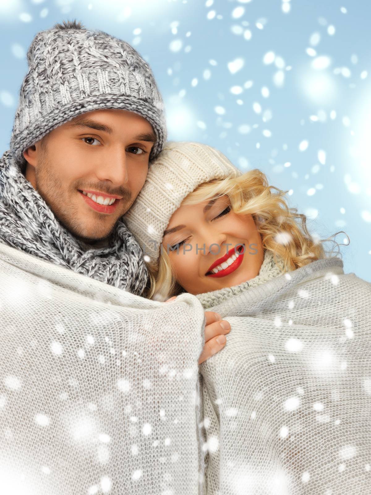 christmas, x-mas, winter, happiness concept - family couple under warm blanket