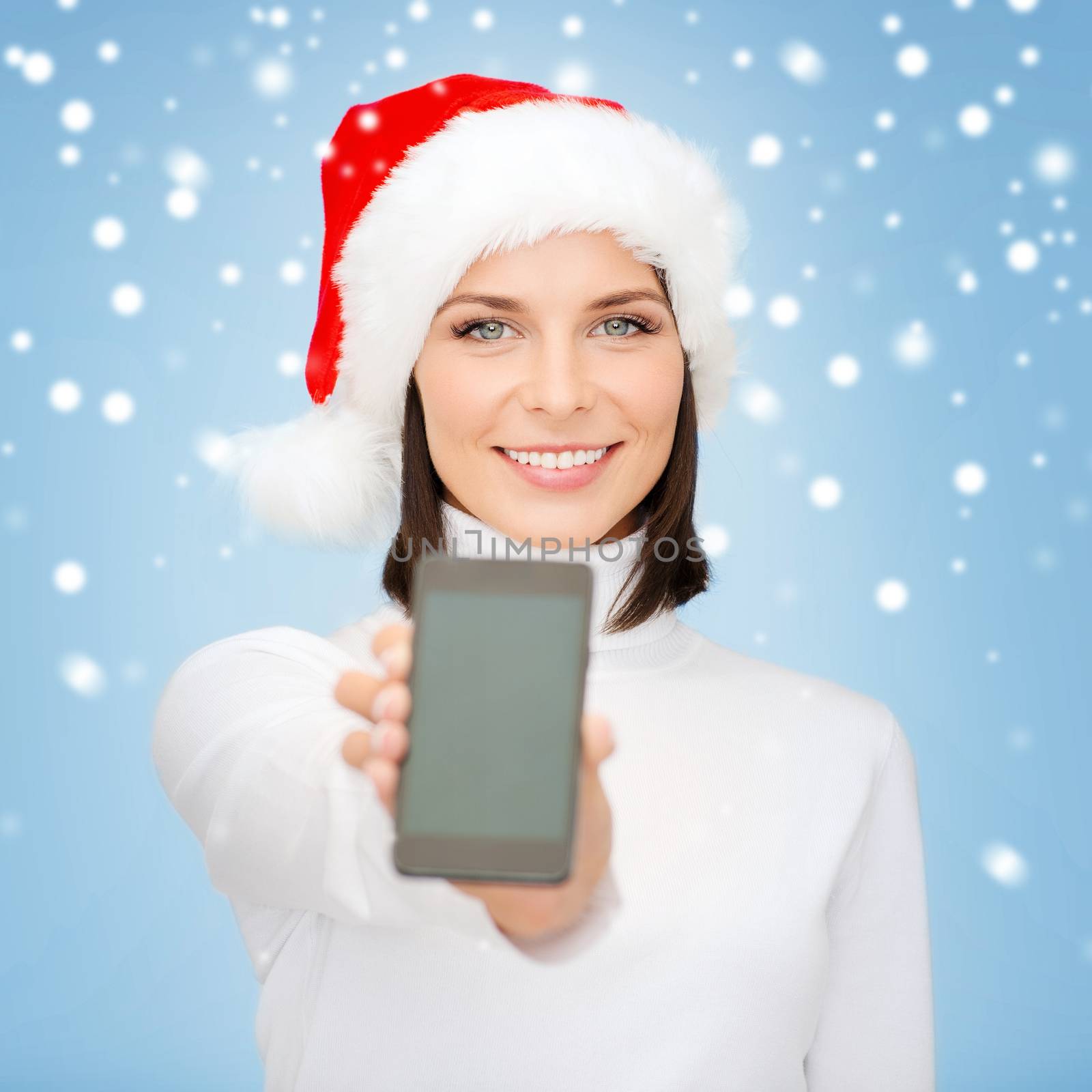 woman in santa helper hat with smartphone by dolgachov