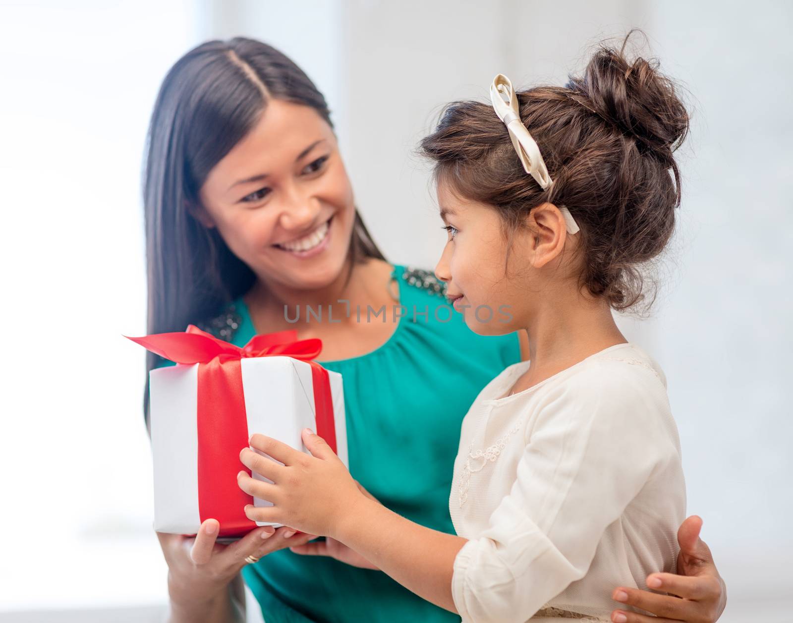 holidays, presents, christmas, x-mas, birthday concept - happy mother and child girl with gift box