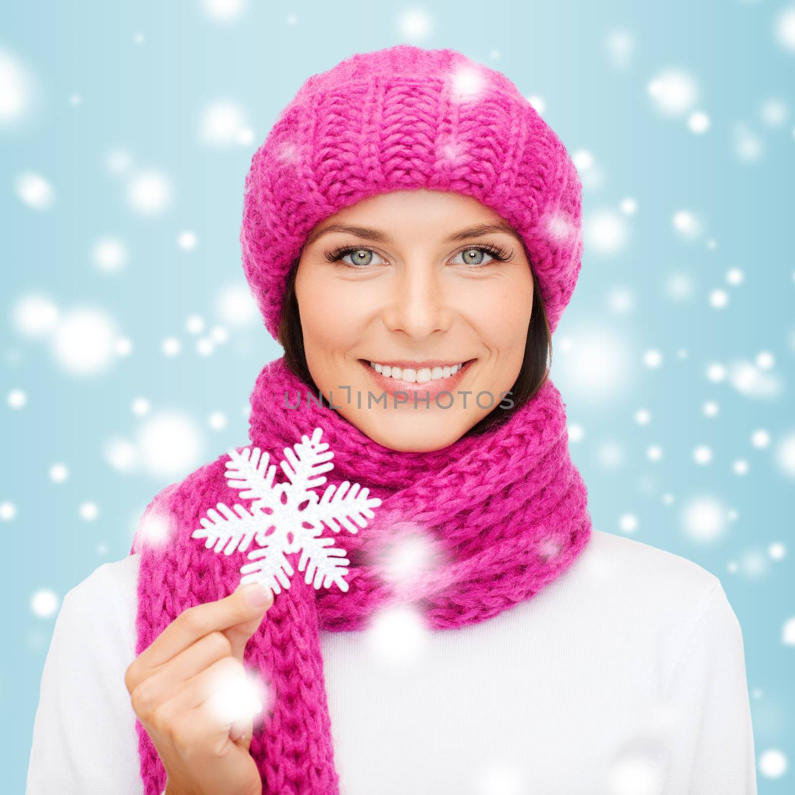 woman in hat and muffler with big snowflake by dolgachov