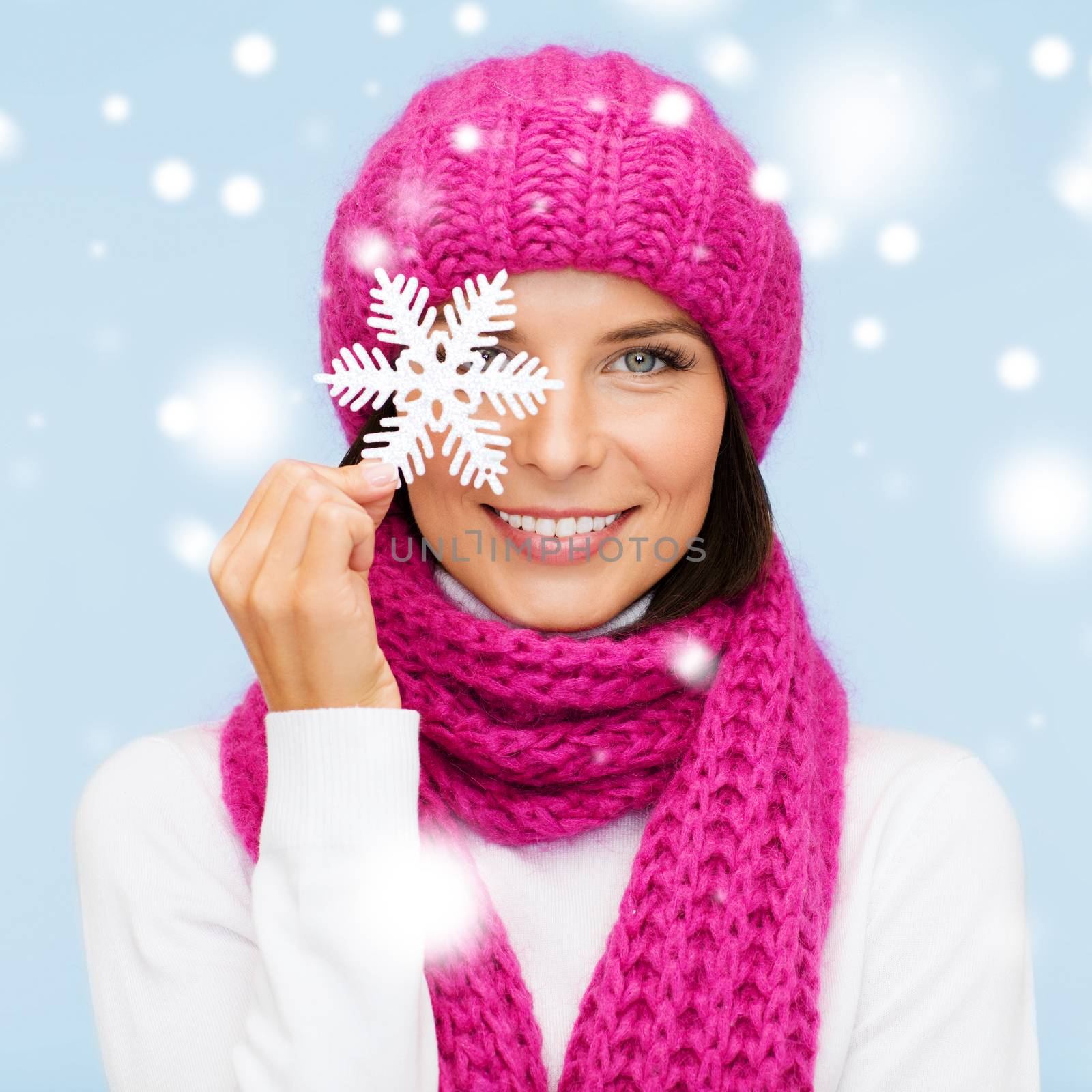 woman in hat and muffler with big snowflake by dolgachov