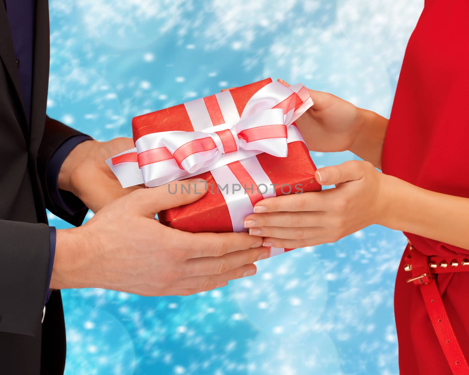 man and woman hands with gift box by dolgachov