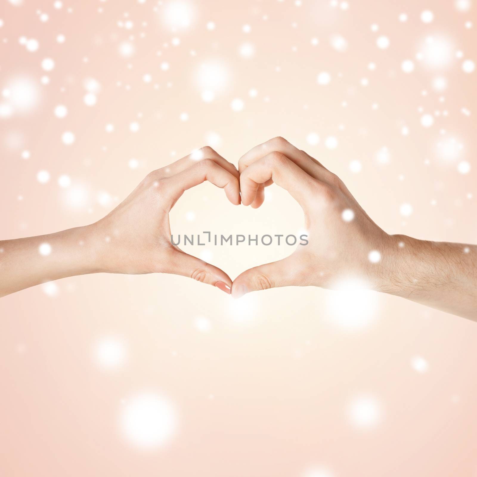 love, family, harmony concept - woman and man hands showing heart shape